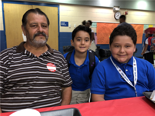 smiling dad with two sons